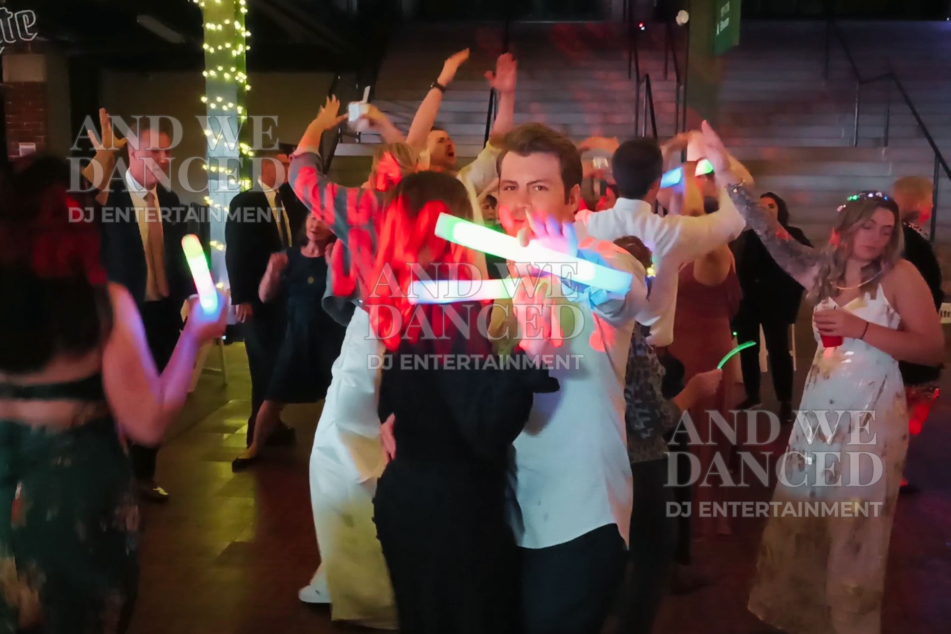 Lively wedding dance floor with guests and glow sticks at Altoona Curve stadium
