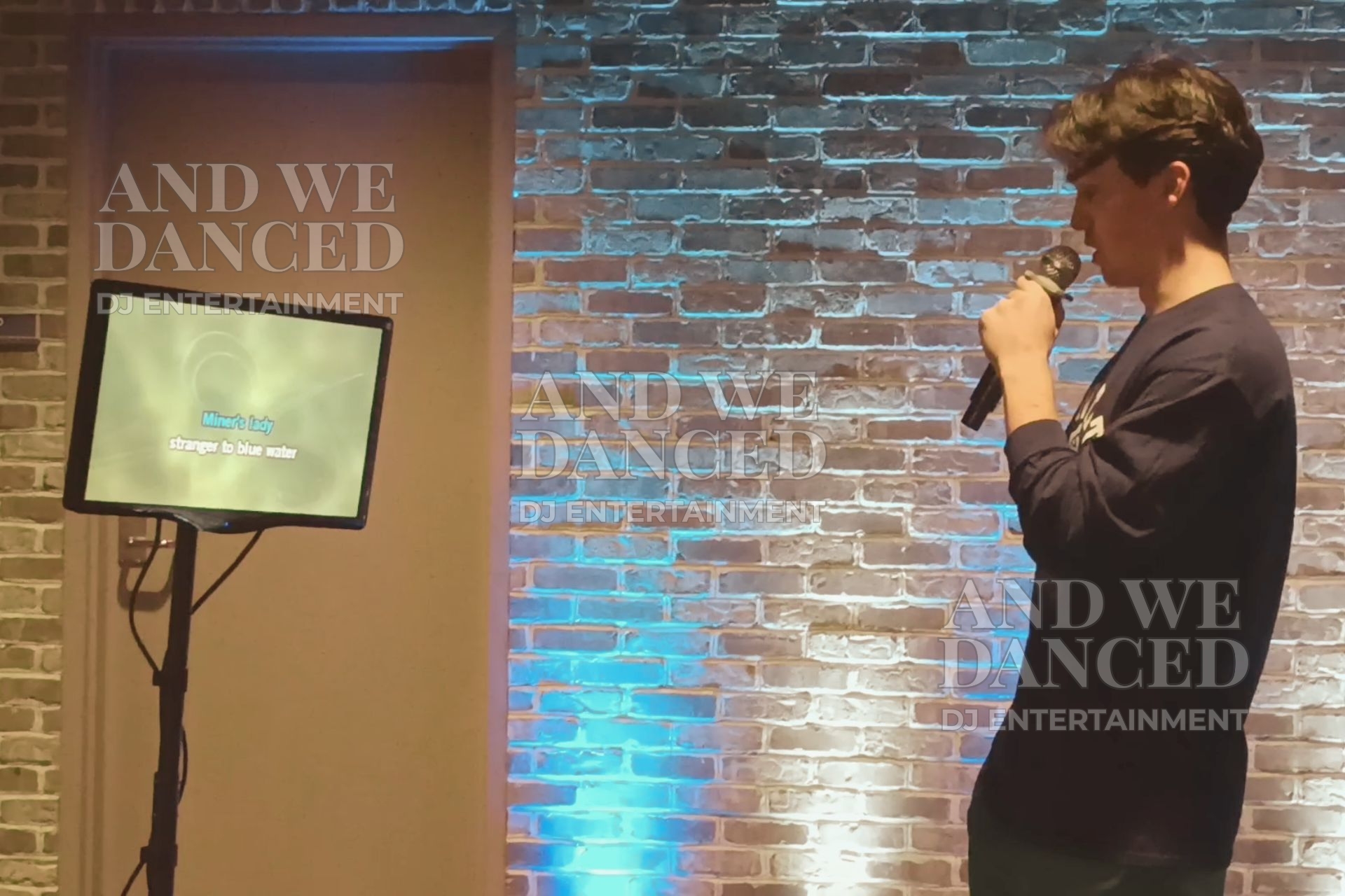 Karaoke performance with blue-white uplights.