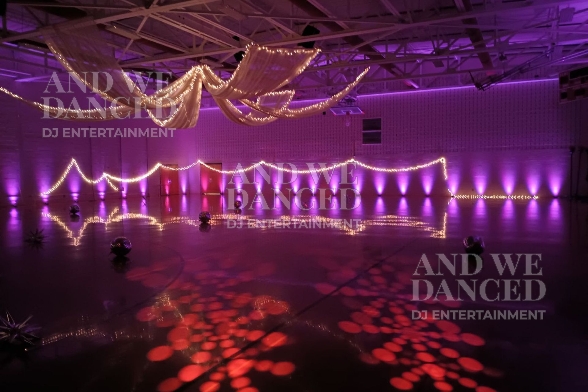 Empty dance floor with uplighting and moving head fixtures set for a prom event